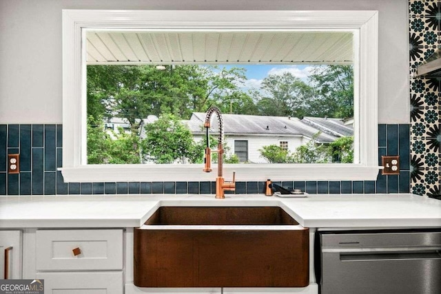 215 Collum St NW, Atlanta, GA 30314 - kitchen featuring light countertops, tasteful backsplash, white cabinetry, a sink, and stainless steel dishwasher