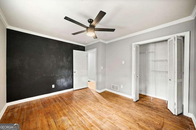 215 Collum St NW, Atlanta, GA 30314 - unfurnished bedroom with baseboards, ornamental molding, visible vents, and wood finished floors
