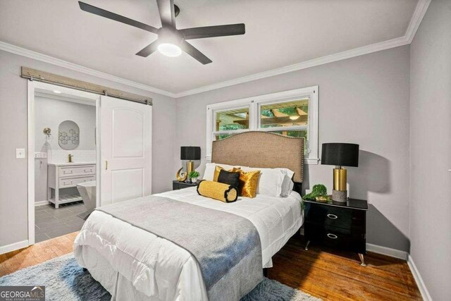 215 Collum St NW, Atlanta, GA 30314 - bedroom featuring ornamental molding, baseboards, a barn door, a ceiling fan, and wood finished floors