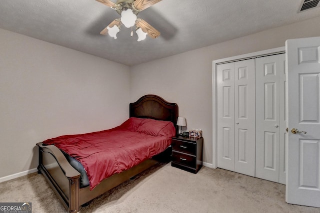 carpeted bedroom featuring a ceiling fan, baseboards, a closet, and visible vents