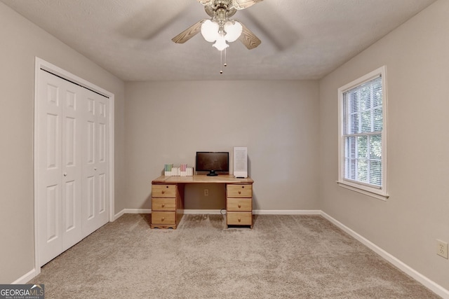 office with light carpet, baseboards, and ceiling fan