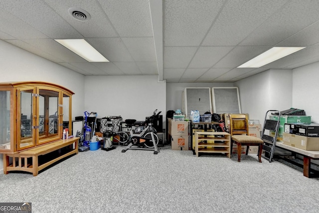 interior space with carpet, visible vents, and a drop ceiling