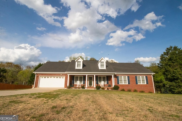 cape cod-style house featuring an attached garage, concrete driveway, a front yard, brick siding, and a porch