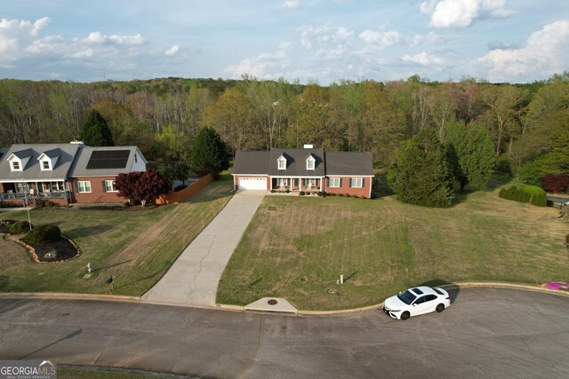 birds eye view of property featuring a wooded view