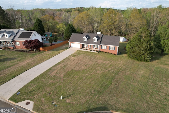 birds eye view of property with a view of trees