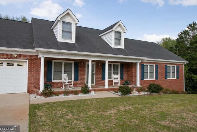 new england style home with a front yard, covered porch, and brick siding