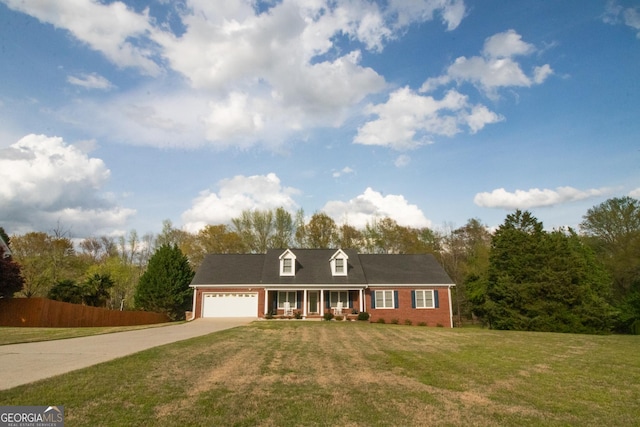 cape cod house with a front yard, concrete driveway, an attached garage, brick siding, and a porch