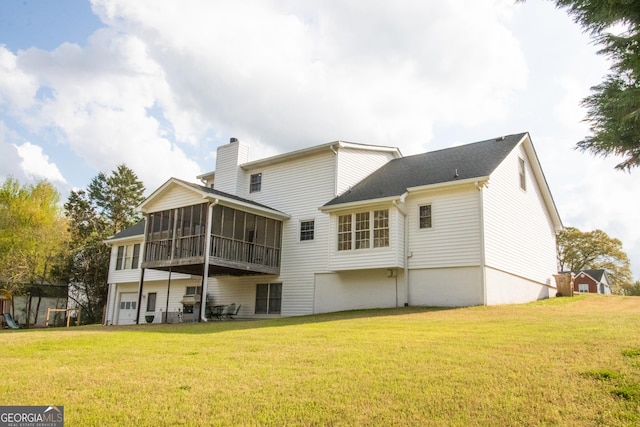rear view of property featuring a chimney, a sunroom, and a lawn