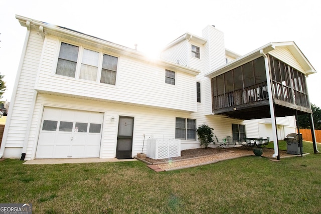 back of property with a lawn, a sunroom, a garage, and cooling unit