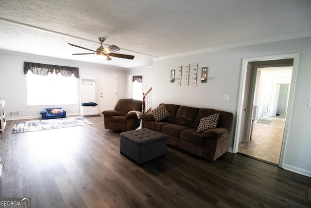 living room with a ceiling fan, dark wood-style floors, and crown molding