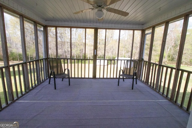 unfurnished sunroom with a ceiling fan