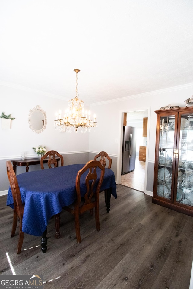dining area featuring baseboards, dark wood-style floors, a chandelier, and crown molding