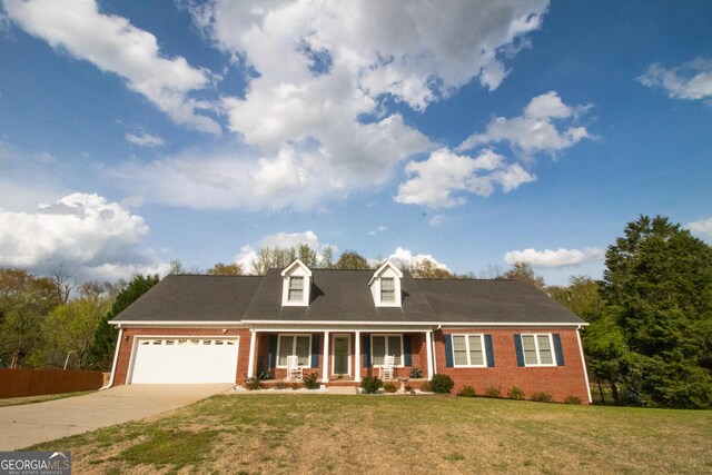 cape cod house with driveway, brick siding, a garage, and covered porch