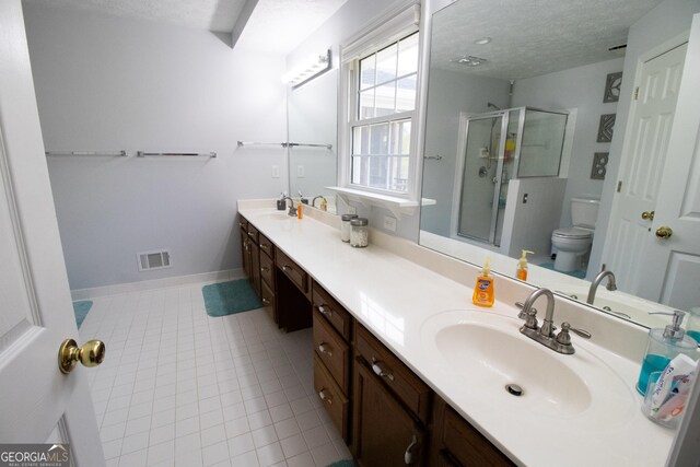 full bath featuring a textured ceiling, visible vents, toilet, an enclosed shower, and a sink