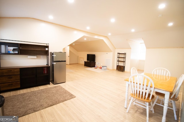 interior space featuring light wood finished floors, vaulted ceiling, and recessed lighting