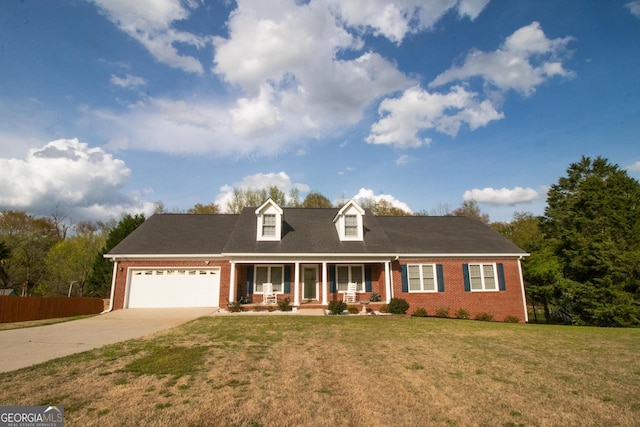 new england style home featuring an attached garage, a front yard, brick siding, driveway, and a porch