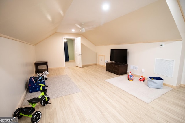 interior space featuring visible vents, vaulted ceiling, a ceiling fan, and wood finished floors