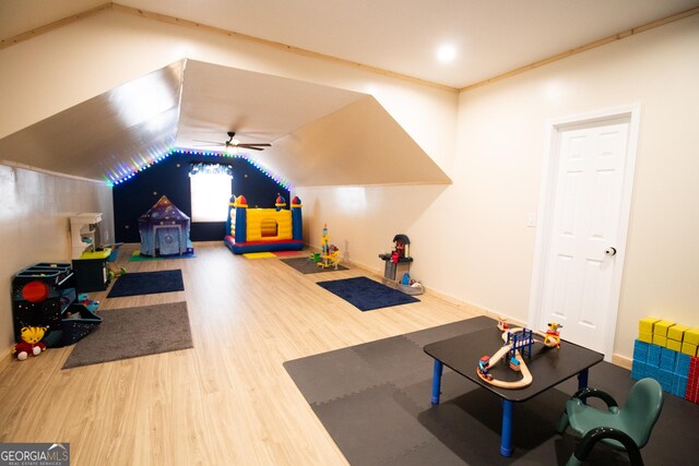 recreation room featuring lofted ceiling, crown molding, wood finished floors, and ceiling fan