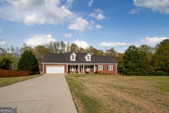 view of front of property with brick siding, a garage, concrete driveway, and covered porch