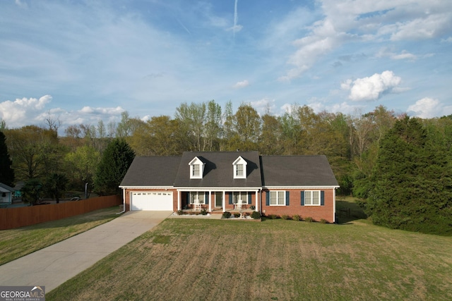 cape cod house with fence, a front yard, brick siding, driveway, and a porch