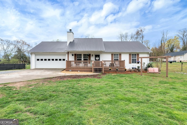 181 King St, Clermont, GA 30527 - rear view of property with concrete driveway, an attached garage, a chimney, and metal roof