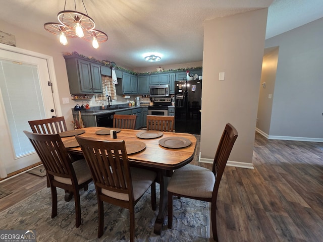 181 King St, Clermont, GA 30527 - dining space with dark wood-style flooring, a chandelier, and baseboards