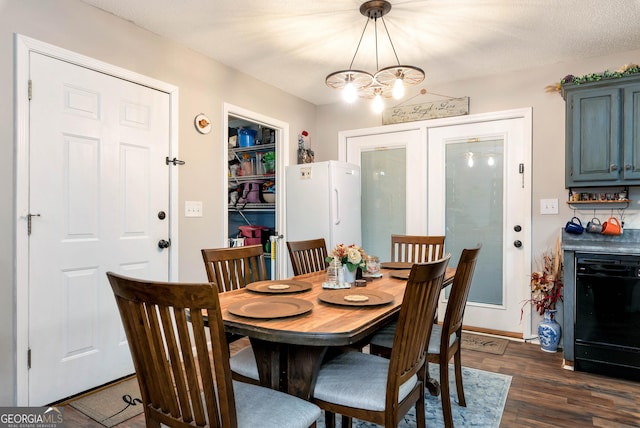 181 King St, Clermont, GA 30527 - dining space with dark wood-style flooring and a chandelier