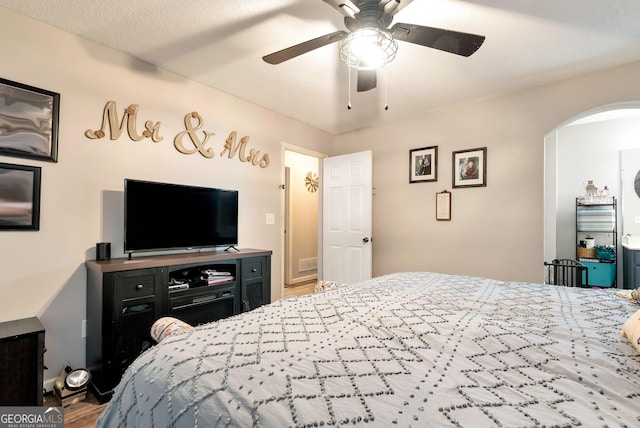 181 King St, Clermont, GA 30527 - bedroom with arched walkways, wood finished floors, and ceiling fan