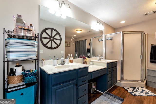 181 King St, Clermont, GA 30527 - full bath with wood finished floors, a shower stall, two vanities, and recessed lighting