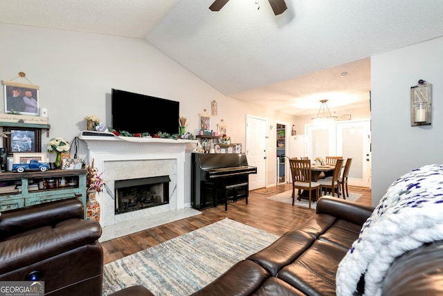 181 King St, Clermont, GA 30527 - living room featuring a ceiling fan, vaulted ceiling, wood finished floors, and a high end fireplace