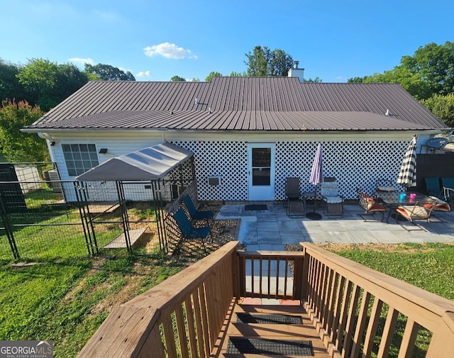 181 King St, Clermont, GA 30527 - back of house with fence, metal roof, a patio, and a chimney