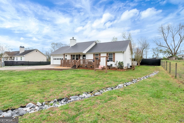 181 King St, Clermont, GA 30527 - view of front facade with concrete driveway, metal roof, a garage, a wooden deck, and a chimney