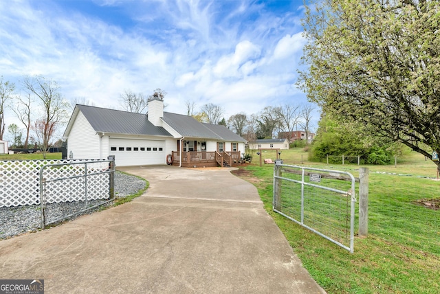 181 King St, Clermont, GA 30527 - ranch-style house featuring concrete driveway, an attached garage, metal roof, a deck, and a chimney