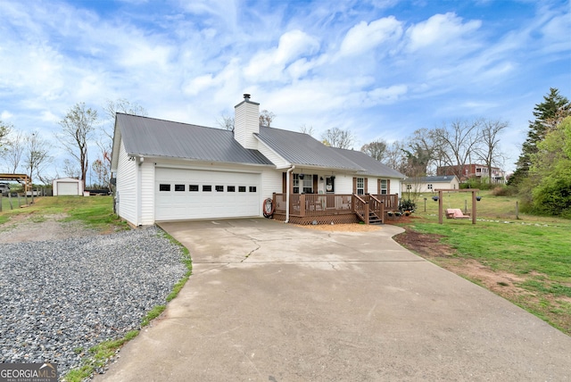 181 King St, Clermont, GA 30527 - ranch-style house with a porch, a garage, a front lawn, concrete driveway, and metal roof