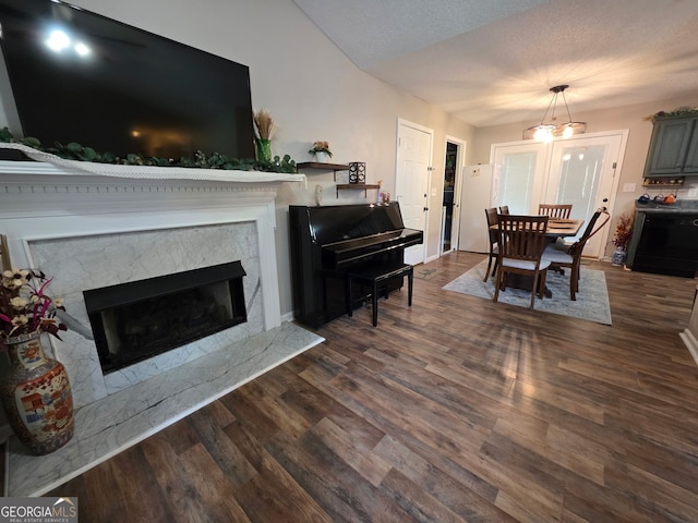 181 King St, Clermont, GA 30527 - living room with dark wood-style floors, a premium fireplace, a chandelier, and baseboards