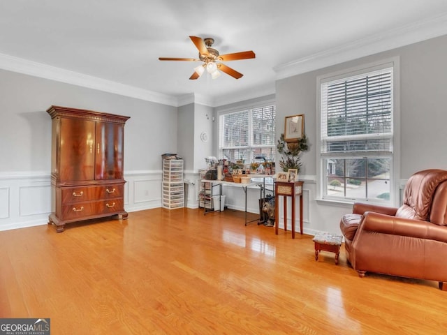 5454 Alanis Pl SE Unit 19, Mableton, GA 30126 - living area featuring a ceiling fan, wood finished floors, ornamental molding, a wainscoted wall, and a decorative wall