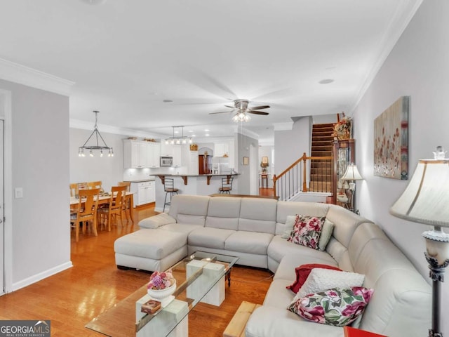 5454 Alanis Pl SE Unit 19, Mableton, GA 30126 - living area with ornamental molding, stairs, a ceiling fan, and light wood-style floors
