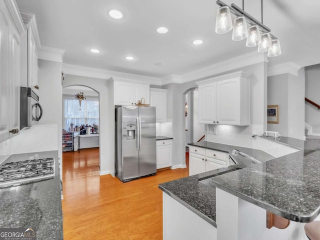5454 Alanis Pl SE Unit 19, Mableton, GA 30126 - kitchen with appliances with stainless steel finishes, arched walkways, white cabinetry, ornamental molding, and recessed lighting