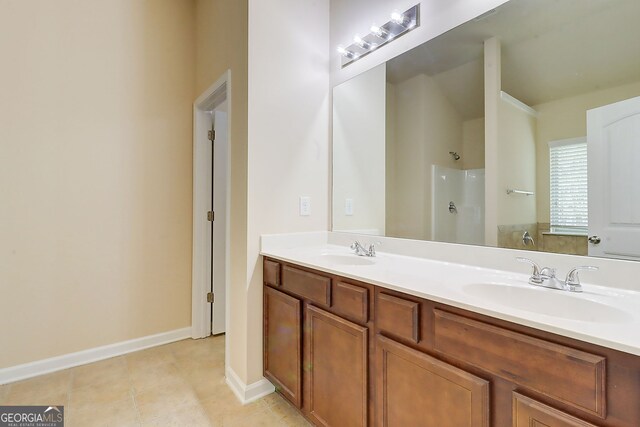 2205 Capella Cir SW, South Fulton, GA 30331 - bathroom with baseboards, double vanity, a sink, and walk in shower