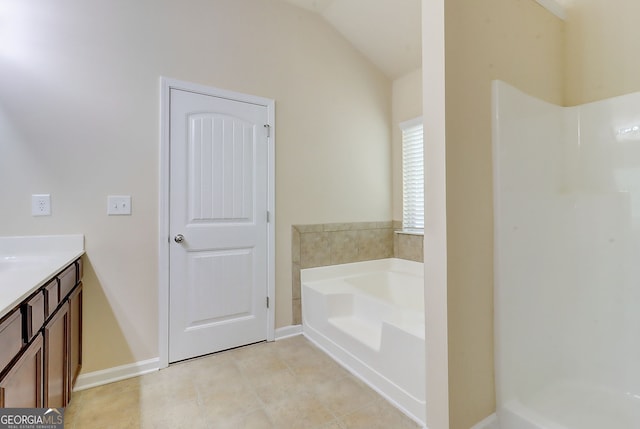 2205 Capella Cir SW, South Fulton, GA 30331 - full bath featuring a shower, vanity, vaulted ceiling, baseboards, and a garden tub