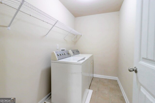2205 Capella Cir SW, South Fulton, GA 30331 - clothes washing area featuring baseboards, independent washer and dryer, laundry area, and light tile patterned flooring