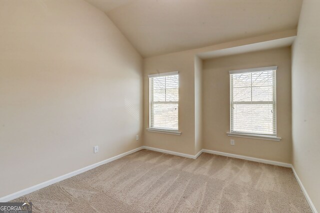 2205 Capella Cir SW, South Fulton, GA 30331 - unfurnished room with baseboards, lofted ceiling, and light colored carpet