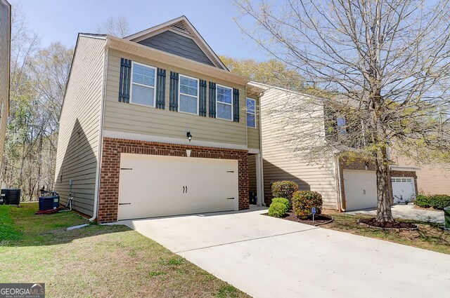 2205 Capella Cir SW, South Fulton, GA 30331 - view of front facade with central AC unit, an attached garage, brick siding, and concrete driveway