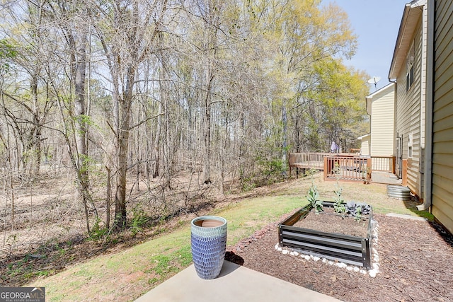 2205 Capella Cir SW, South Fulton, GA 30331 - view of yard with a wooden deck and a vegetable garden