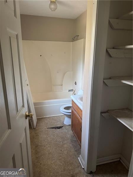 bathroom with toilet, vanity, and shower / bathtub combination