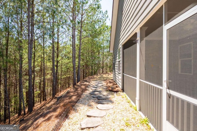 view of property exterior featuring a sunroom