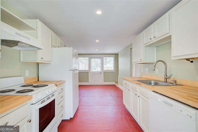 kitchen featuring tile patterned floors, a sink, white appliances, white cabinets, and recessed lighting