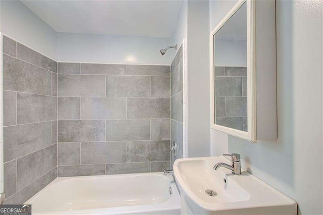 bathroom featuring a sink and bathing tub / shower combination