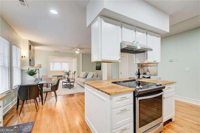 kitchen with white cabinetry, stainless steel electric range, wooden counters, light wood-type flooring, and under cabinet range hood