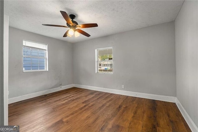 1090 Harwell St NW, Atlanta, GA 30314 - unfurnished room with a textured ceiling, baseboards, ceiling fan, and wood finished floors